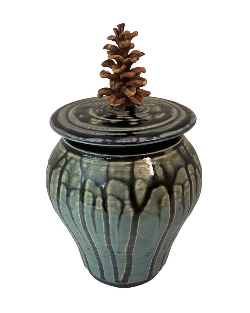 Custom pottery container with pine cone top.